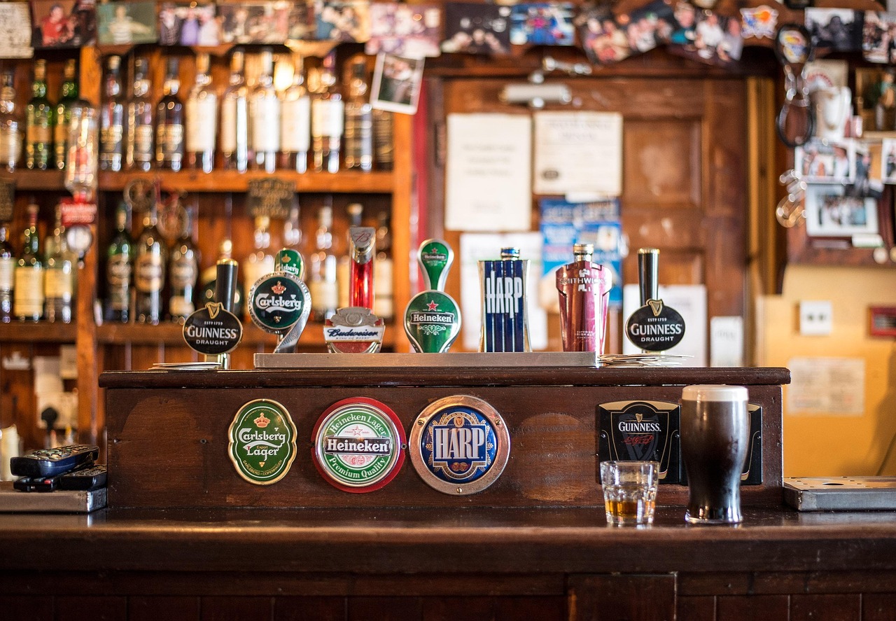 Busy Hobart pub crowd with pints on the bar, showing a full room on a night when punters are still buying fewer beers.