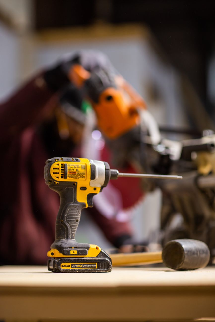 A cordless drill on a bench, used here to illustrate the real-world buyer test of pricing, stock and service.