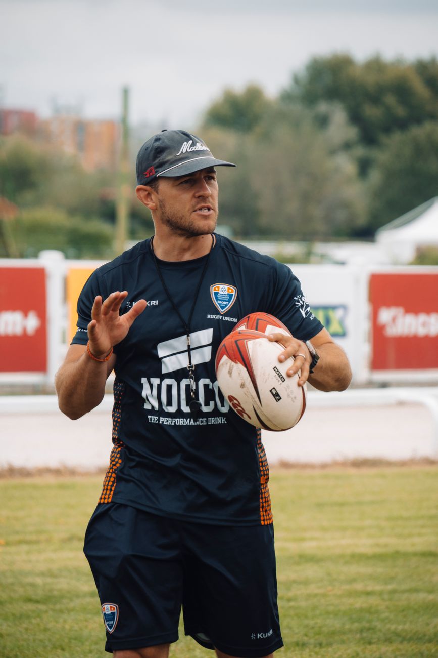 Coach instructing players during rugby training, used to illustrate Queensland's looming State of Origin coaching decision