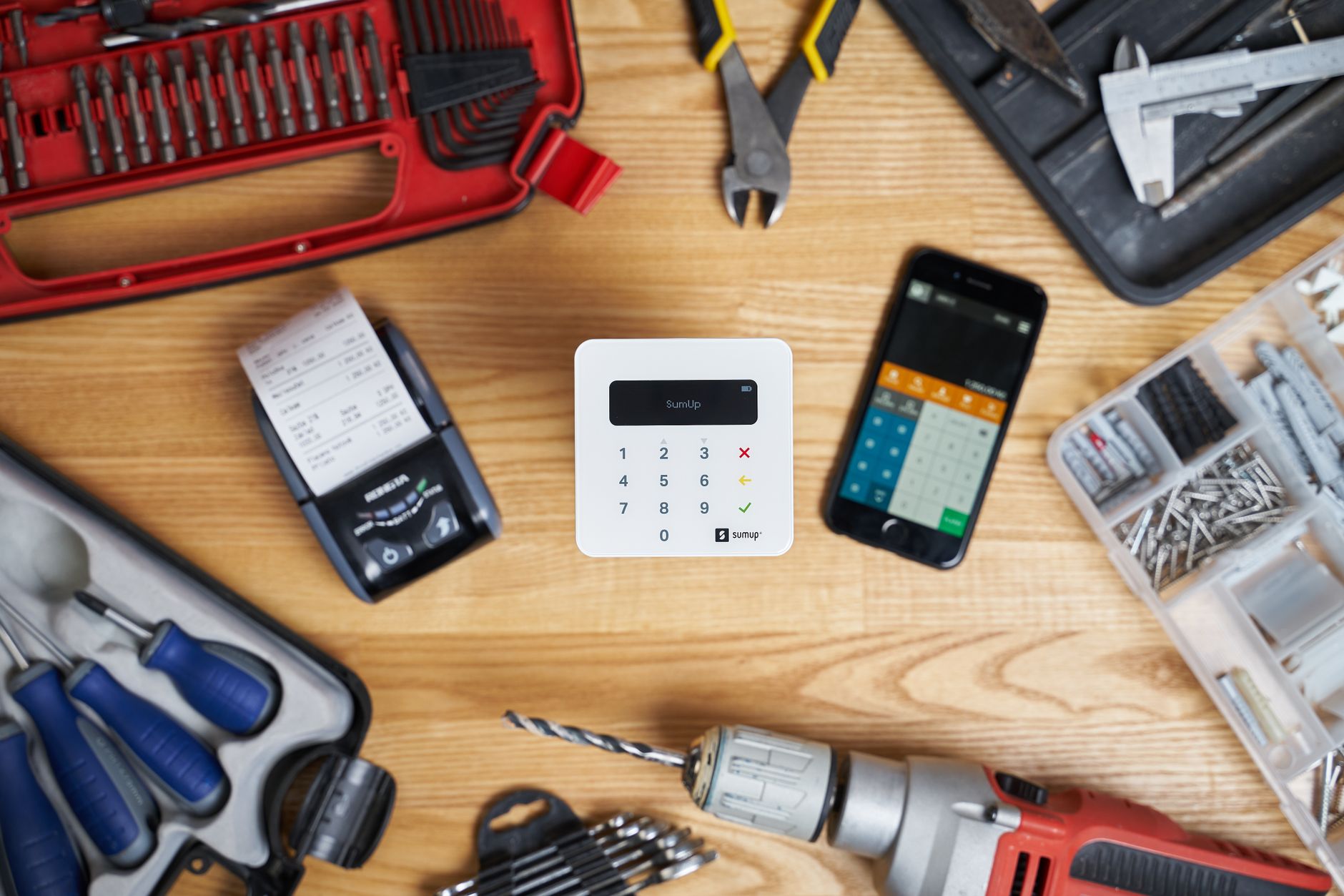 Cash register readout and hand tools on a bench, matching the trade-business and admin-pressure angle of the story