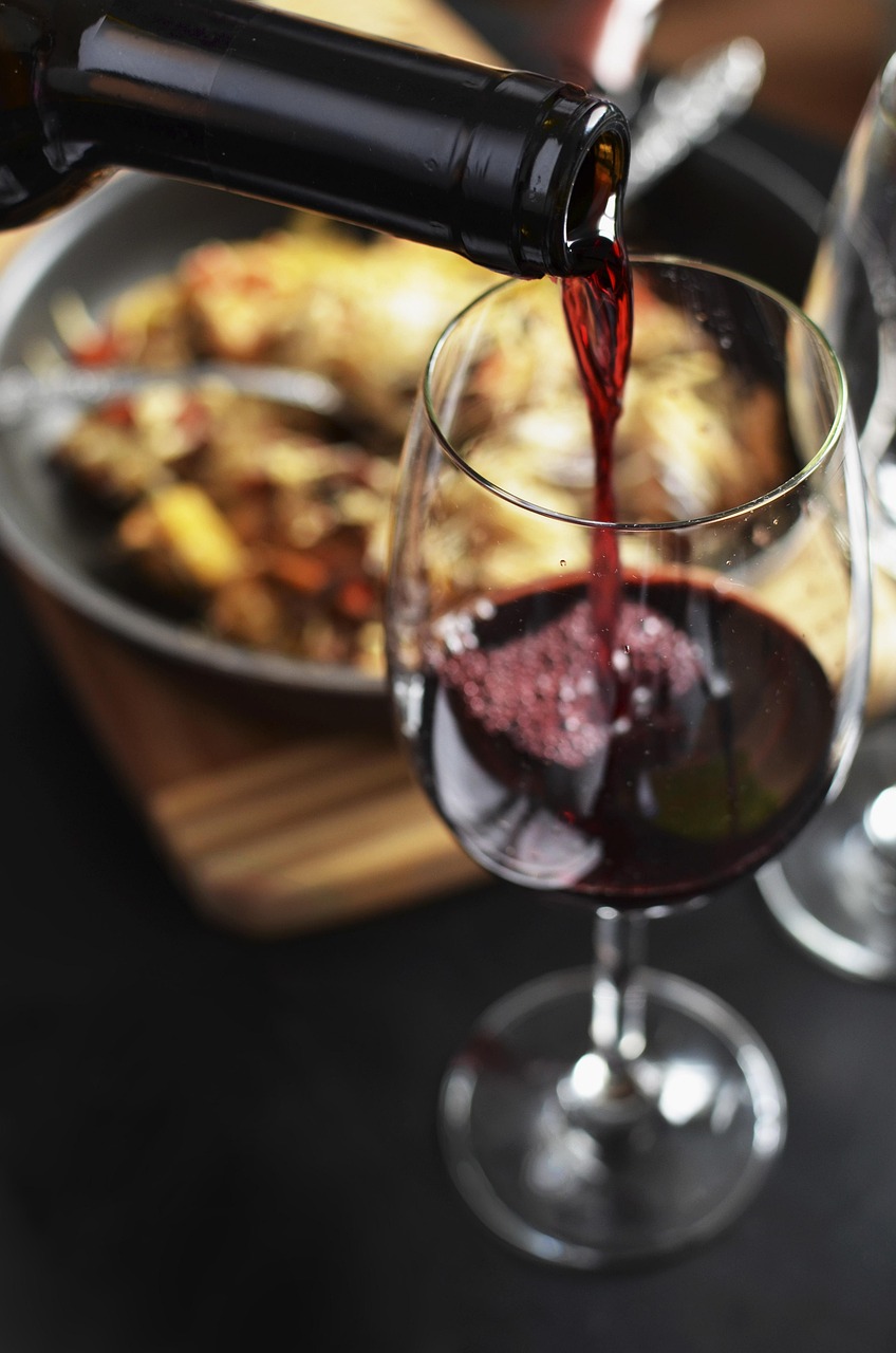 Bottle and glass of red wine, used as the hero image for a story about lightly chilling red wine