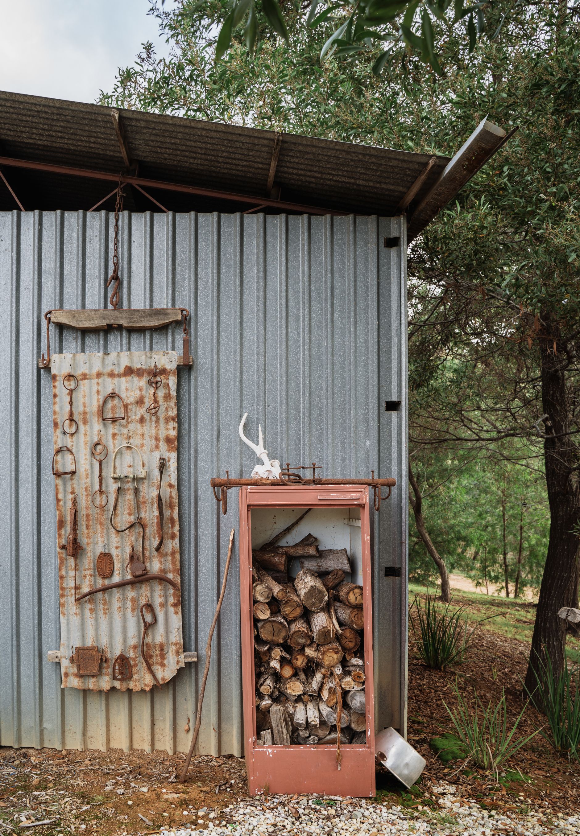 Stacked firewood beside a rural barn, matching the story's focus on winter fuel demand