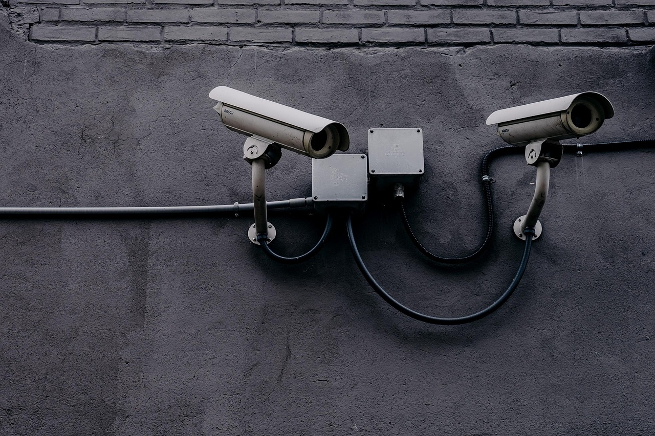 Outdoor home security camera mounted on a house exterior wall