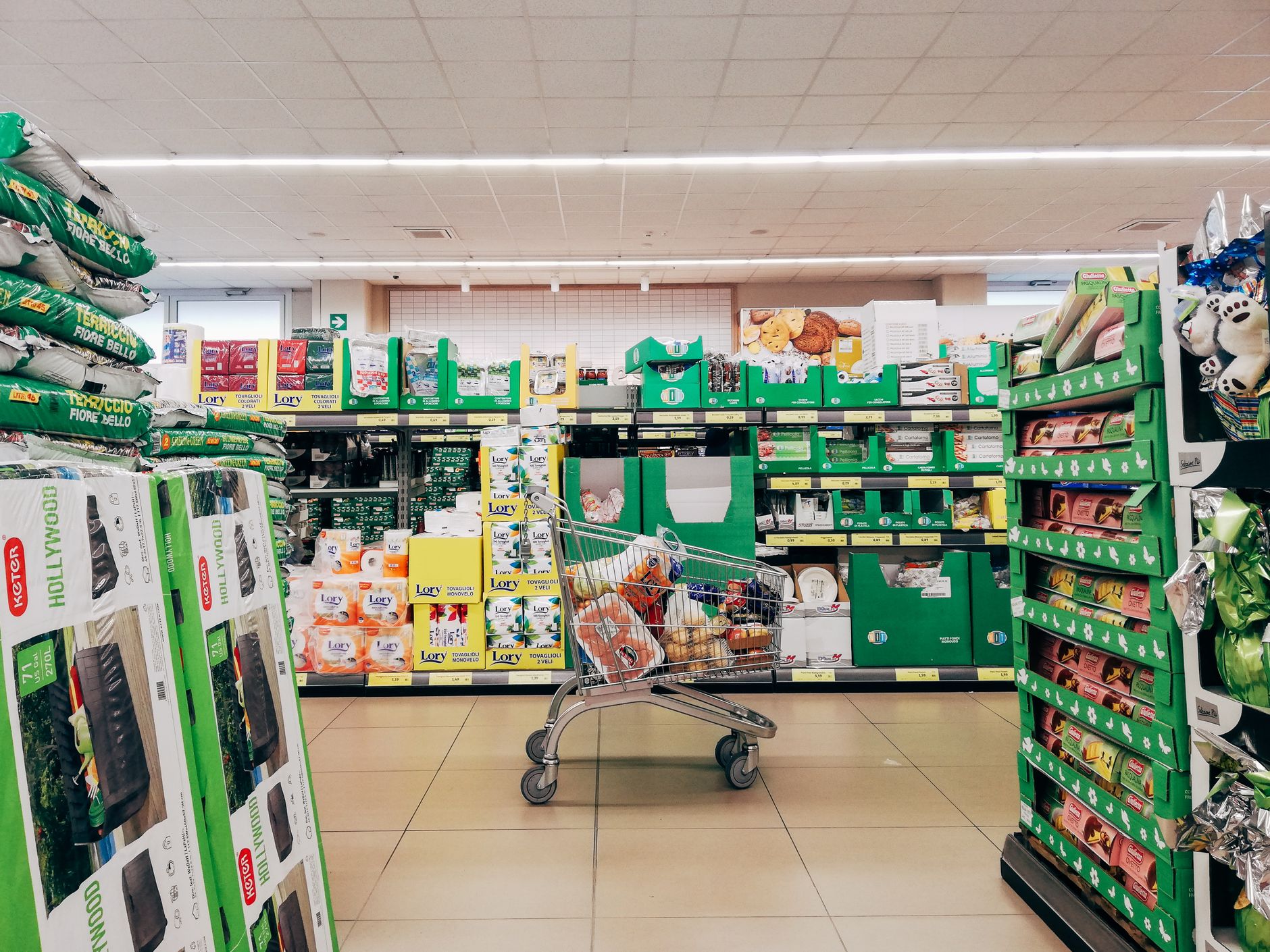 Supermarket shopping trolley in aisle