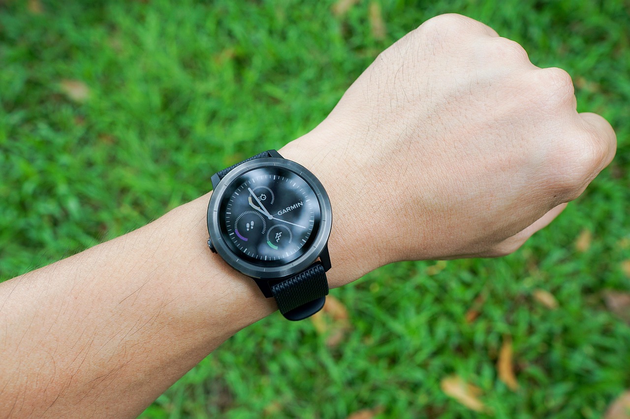 Runner checking a fitness smartwatch during an outdoor workout
