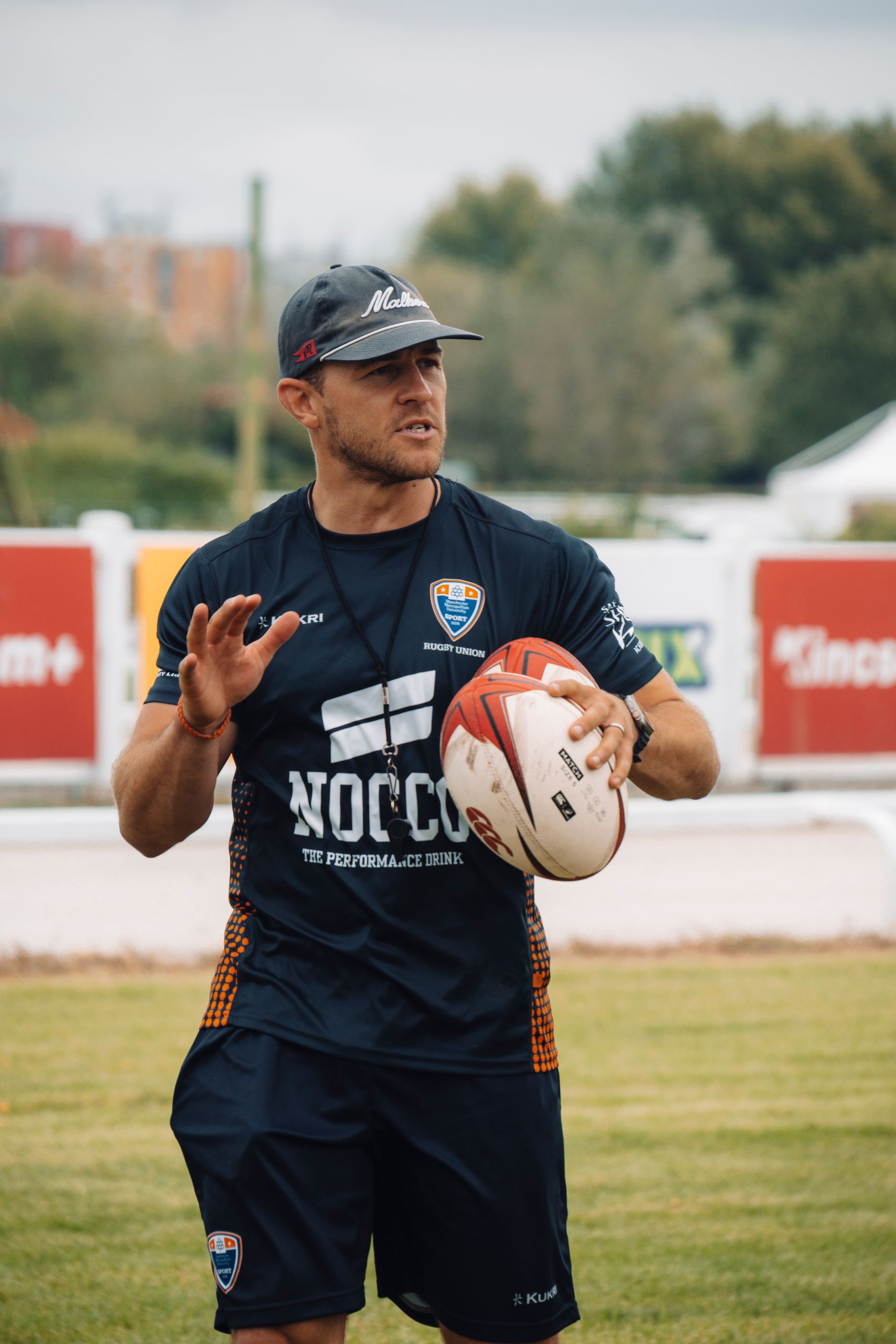 Rugby coach instructing players during a training session